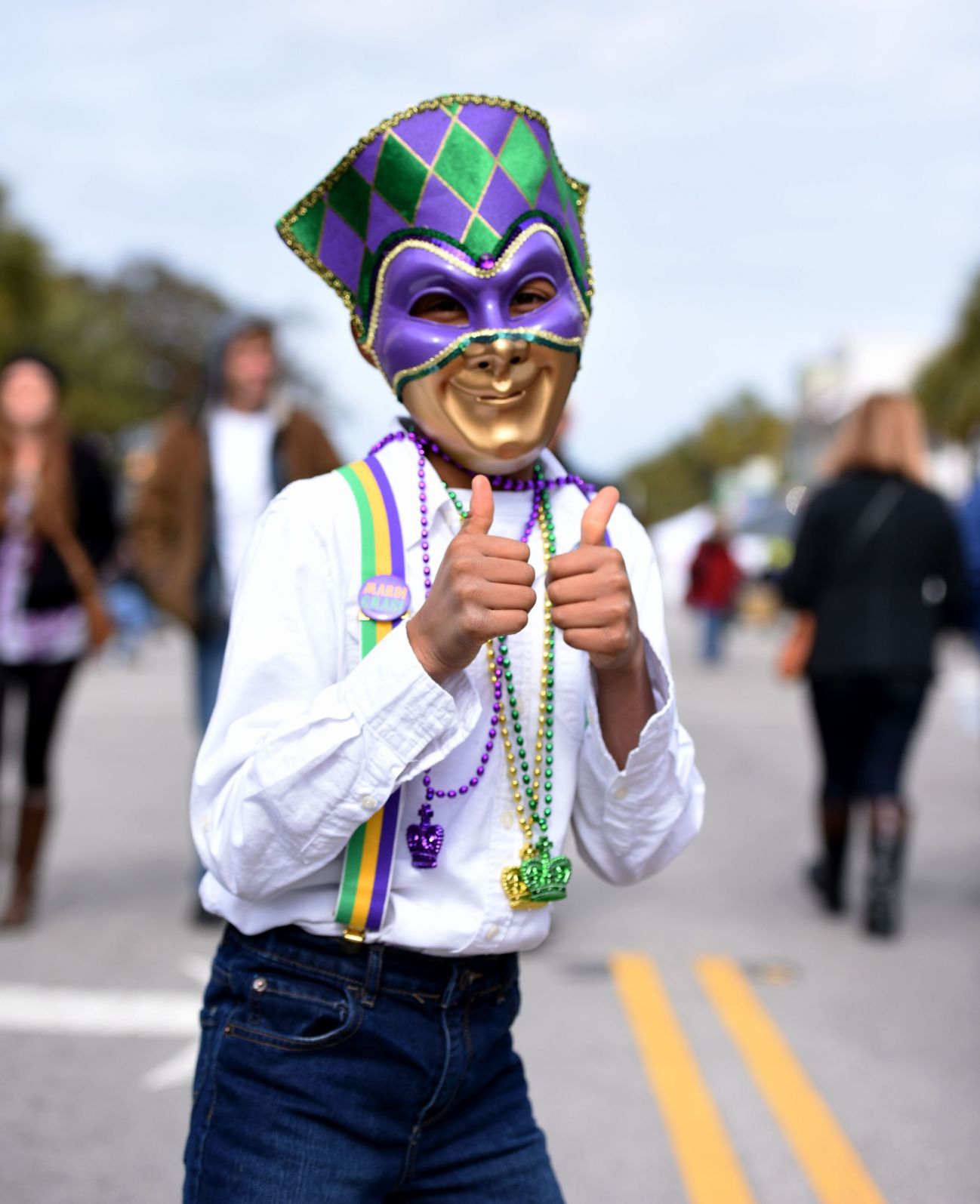 Folly Gras Parade thumbs-up kid